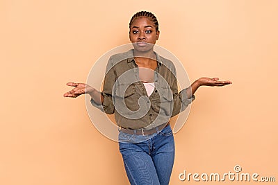 Portrait of hesitate doubtful person shrug shoulders arms palms isolated on beige color background Stock Photo