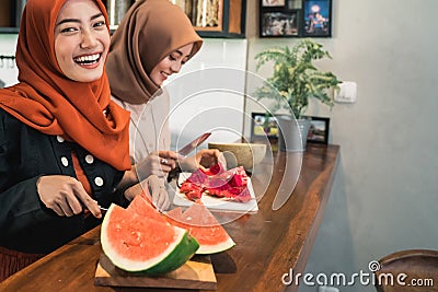 Portrait hijab young woman slice watermelon Stock Photo
