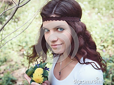 Portrait of hippie girl in forest with flowers Stock Photo