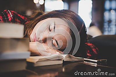 Portrait of hipster teenage sleeping on table at cafe looks tire Stock Photo