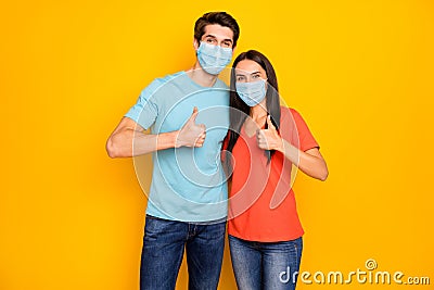 Portrait of his he her she attractive couple guy lady embracing showing thumbup wearing gauze safety mask stop mers cov Stock Photo
