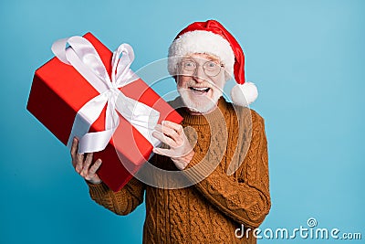 Portrait of his he nice attractive cheerful cheery glad elderly bearded grey-haired Santa father holding in hands big Stock Photo