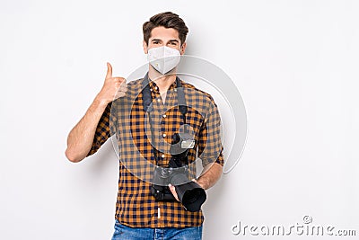 Portrait of his he nice attractive healthy guy showing thumbup holding in hands camera wearing reusable safety mask mers Stock Photo
