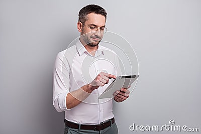 Portrait of his he nice attractive intellectual mature man holding in hands ebook analyzing searching information e Stock Photo