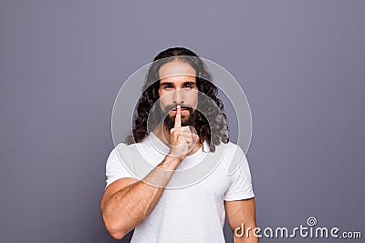 Portrait of his he nice groomed attractive candid minded wavy-haired guy showing shh symbol isolated over gray violet Stock Photo