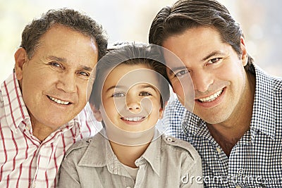 Portrait Of Hispanic Grandfather, Adult Father And Son Relaxing Stock Photo