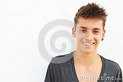 Portrait Of Hispanic Teenage Boy Leaning Against Wall Stock Photo