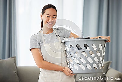 Portrait, home and woman with a laundry basket, smile and cleaning with chores, housekeeping and maid. Face, female Stock Photo