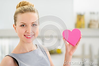 Portrait of housewife showing decorative heart Stock Photo