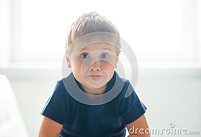 Portrait of hysterical boy. Upset caucasian kid crying at home. Stock Photo