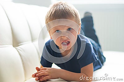 Portrait of hysterical boy. Upset caucasian kid crying at home. Stock Photo