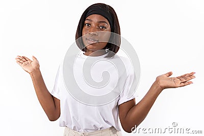 Portrait of ignorant young woman shrugging shoulders Stock Photo