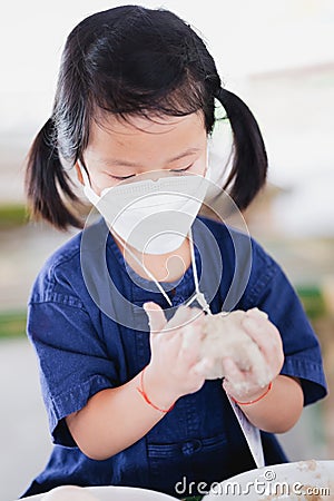 Portrait image child 5 years old. Asian girl learning how to preserve food or make salted egg. Stock Photo