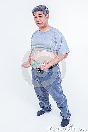 Portrait images of Obese men use a tape measure Fasten his belly fat Stock Photo