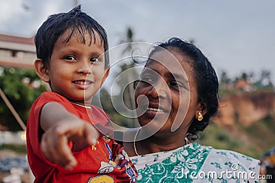Portrait indian mother with child on Varkala during puja ceremony Editorial Stock Photo