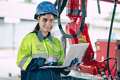 Portrait Indian young smart engineer woman worker confident look with safety suit work in advance technology industry Stock Photo