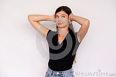 Portrait of indifferent young woman covering ears with hands Stock Photo