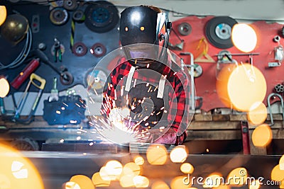 Portrait industrial worker craft labourer factory welding steel structure with spark Stock Photo