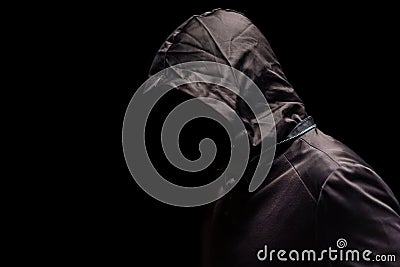 Portrait of Invisible man in the hood on black background Stock Photo