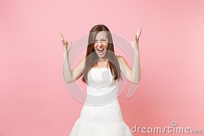 Portrait of irritated angry bride woman in beautiful white wedding dress stand screaming spreading hands isolated on Stock Photo