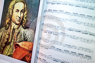 A portrait of Johann Sebastian Bach on the opened sheet music. Interior of musical room. Famous people and their works. Editorial Stock Photo