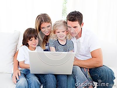 Portrait of a jolly family using a laptop Stock Photo