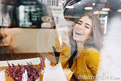 Portrait joyful charming young woman in window comfortable cafe chilling inside on cold winter weather. Having fun Stock Photo