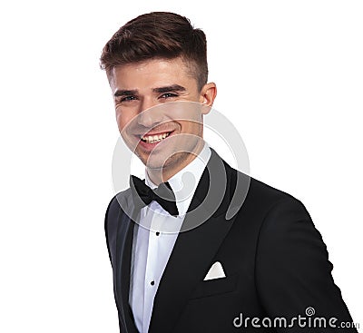 Portrait of joyful handsome man wearing black tuxedo Stock Photo
