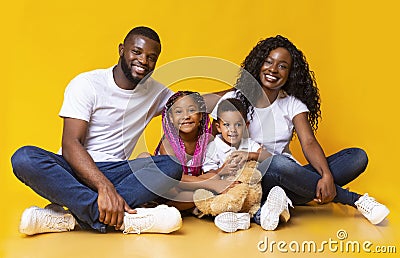 Portrait of joyful young afro family with two little kids Stock Photo