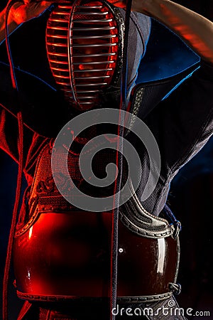 Portrait of kendo fighter in uniform and helmet Stock Photo