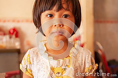 Portrait of a Khmer little girl in vintage dress, cute black eyes looking at camera Editorial Stock Photo
