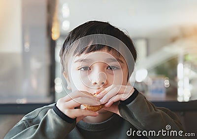 Portrait Kid bitting hash brown for breakfast, Healthy Child boy eating English Breakfast in the cafe or restaurant, Healthy food Stock Photo
