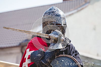 Portrait of knight in helmet with sword in hand_ Editorial Stock Photo