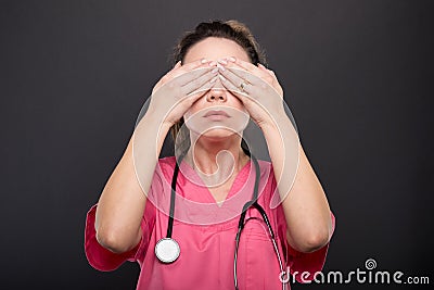 Portrait of lady doctor covering eyes like not seeing Stock Photo