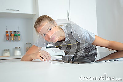 Portrait lady fitting induction hob Stock Photo