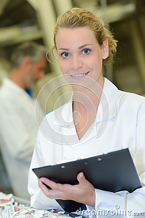 Portrait lady in white jacket holding clipboard Stock Photo