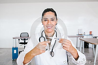 Portrait Of latin Female Doctor Wearing White Coat With Stethoscope In Hospital Office in Mexico city Stock Photo