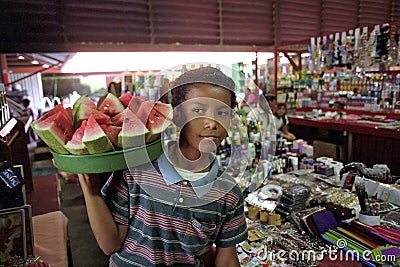 Portrait of Latino boy selling water melons Editorial Stock Photo