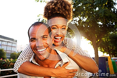 Laughing couple with man and woman in embrace Stock Photo