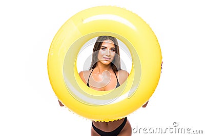 Portrait of a laughing girl dressed in swimsuit looking through inflatable ring isolated over white background Stock Photo