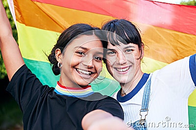 Portrait, lesbian and couple with flag for pride, freedom and happy or bonding at festival. Face, lesbian couple and Stock Photo