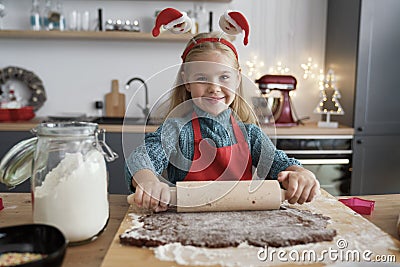Portrait of girl rolling gingerbread dough Stock Photo