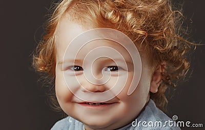 Portrait of little baby. Concept of kids face close-up. Head shoot children portrait. Smiling infant, cute smile. Stock Photo