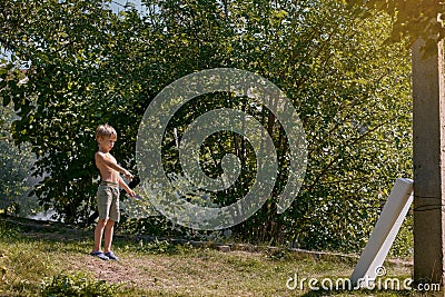 Little boy with kunai at summer Stock Photo