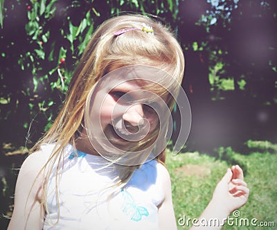 Portrait of a little blonde smiling girl; soft retro style Stock Photo