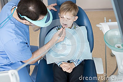 Dentist Treating Little Boy Stock Photo