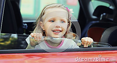 Portrait little child passenger sitting in a red car Stock Photo