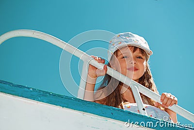 Portrait of little cute girl enjoying playing on boat Stock Photo