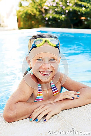 Portrait of little cute girl in the swimming pool. Stock Photo