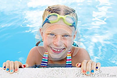 Portrait of little cute girl in the swimming pool. Stock Photo